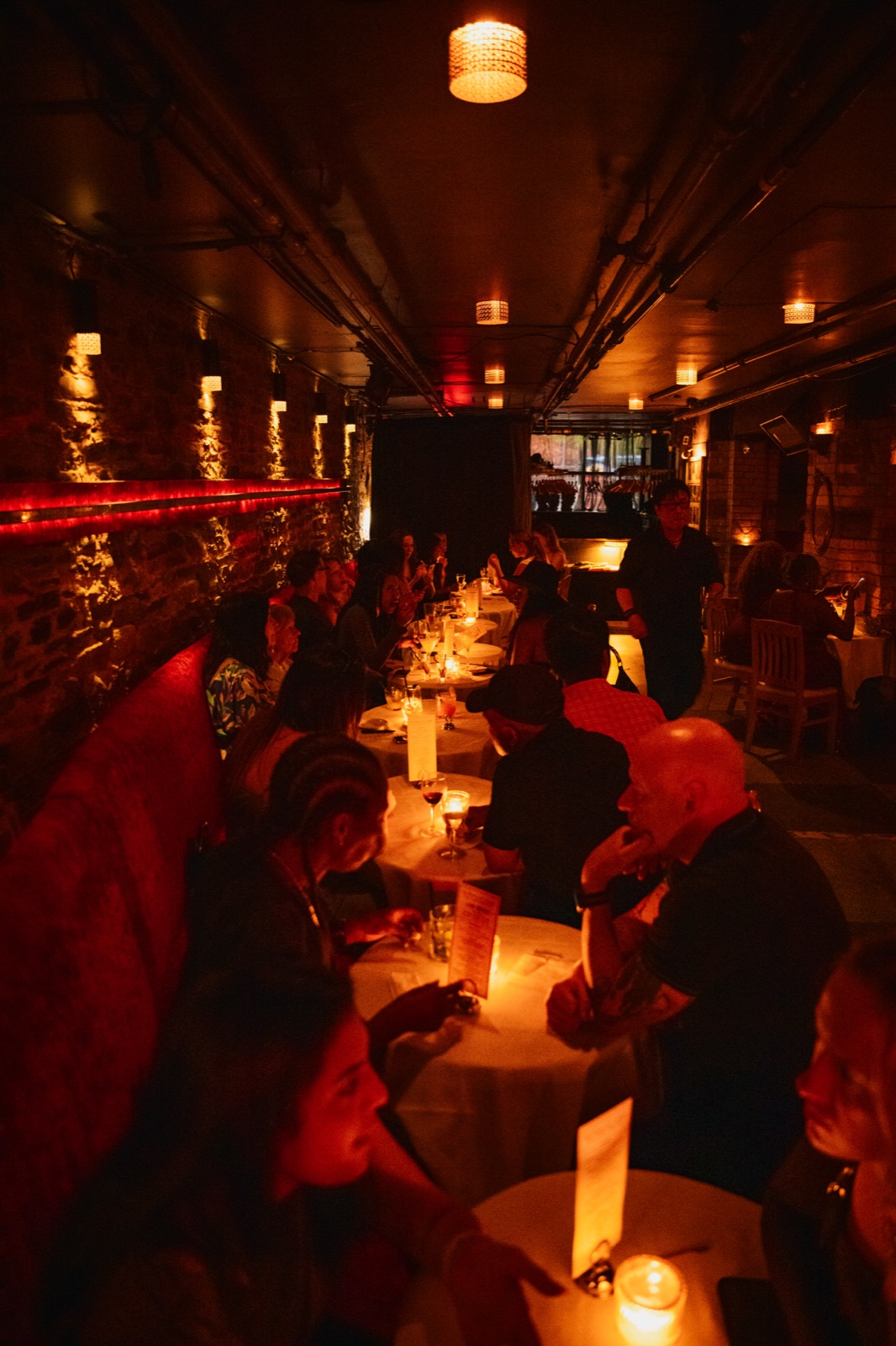 The length of the room on a busy night, every table full