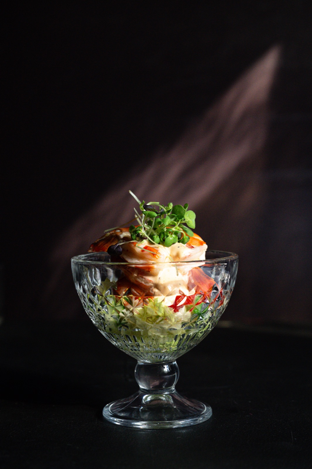 Chilled jumbo black tiger shrimp cocktail in a coupe glass